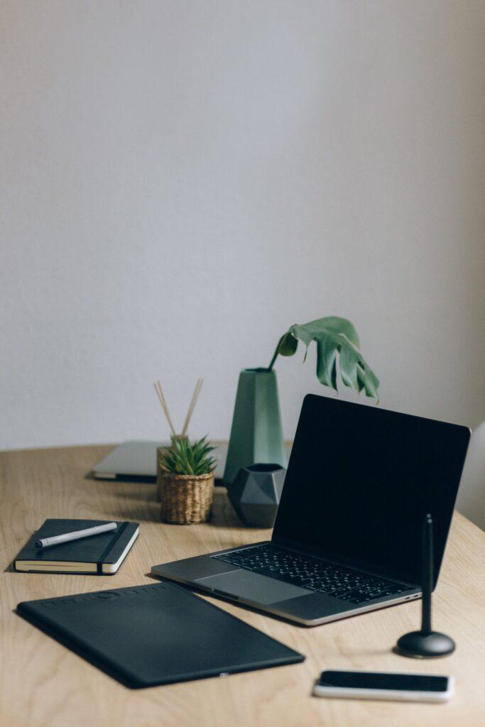 Free Black Laptop Computer On Brown Wooden Table Stock Photo